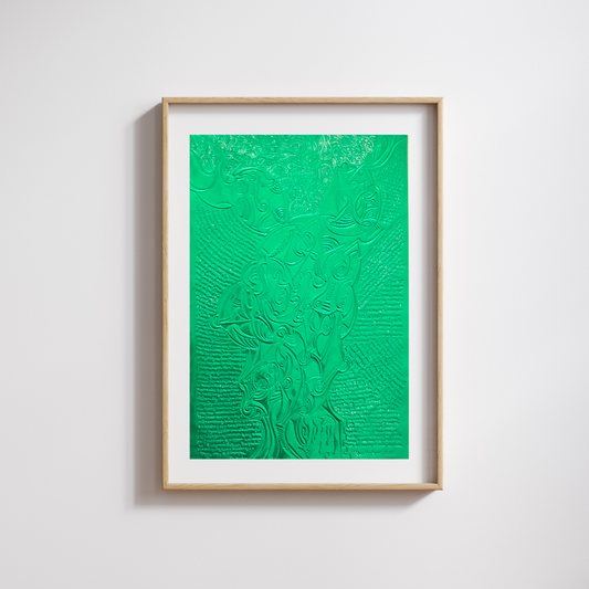 A framed bright-green metal engraving in a wooden, minimalist frame against a white wall.